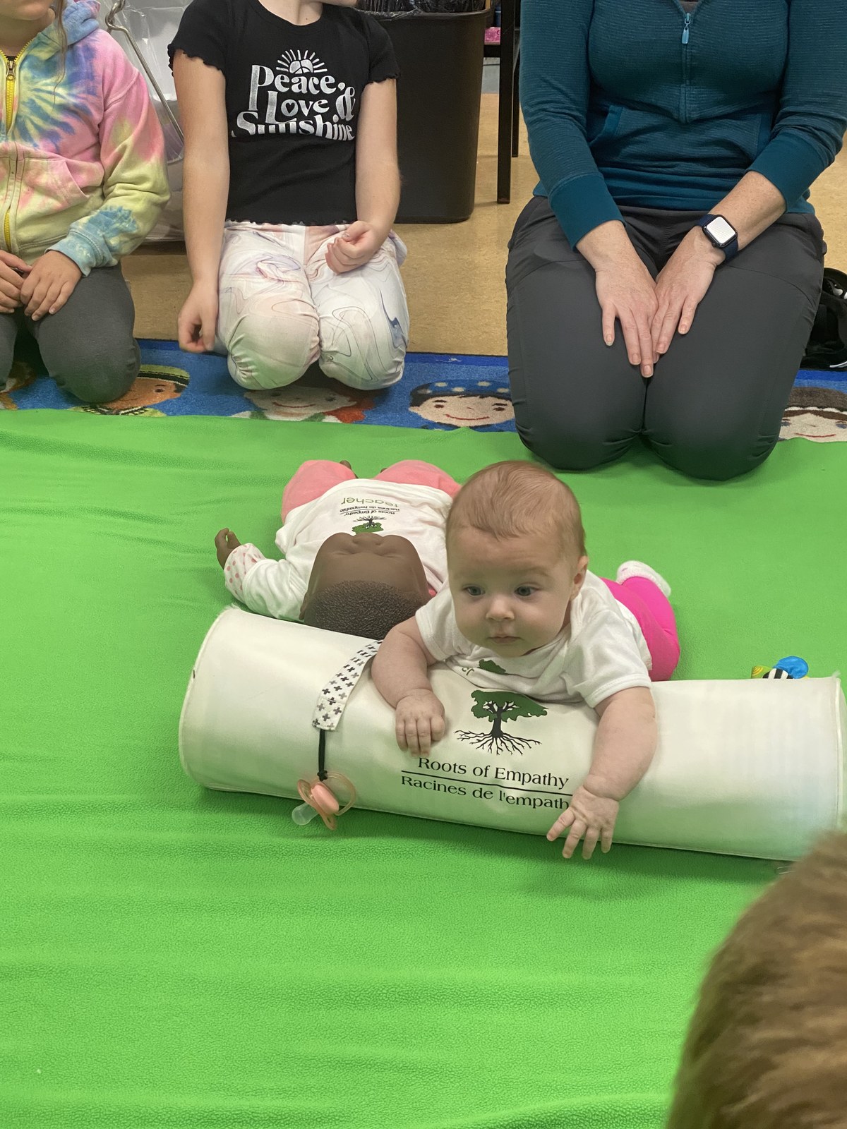 A baby - the &lsquo;tiny teacher&rsquo; - at the centre of a Roots of Empathy classroom session